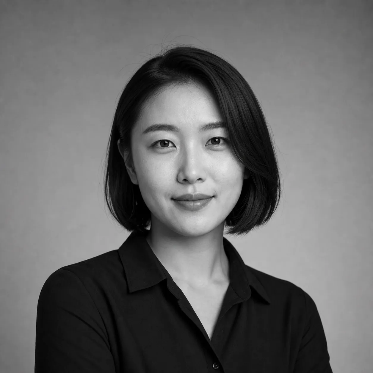 Black and white studio portrait of a presenter with a sleek bob